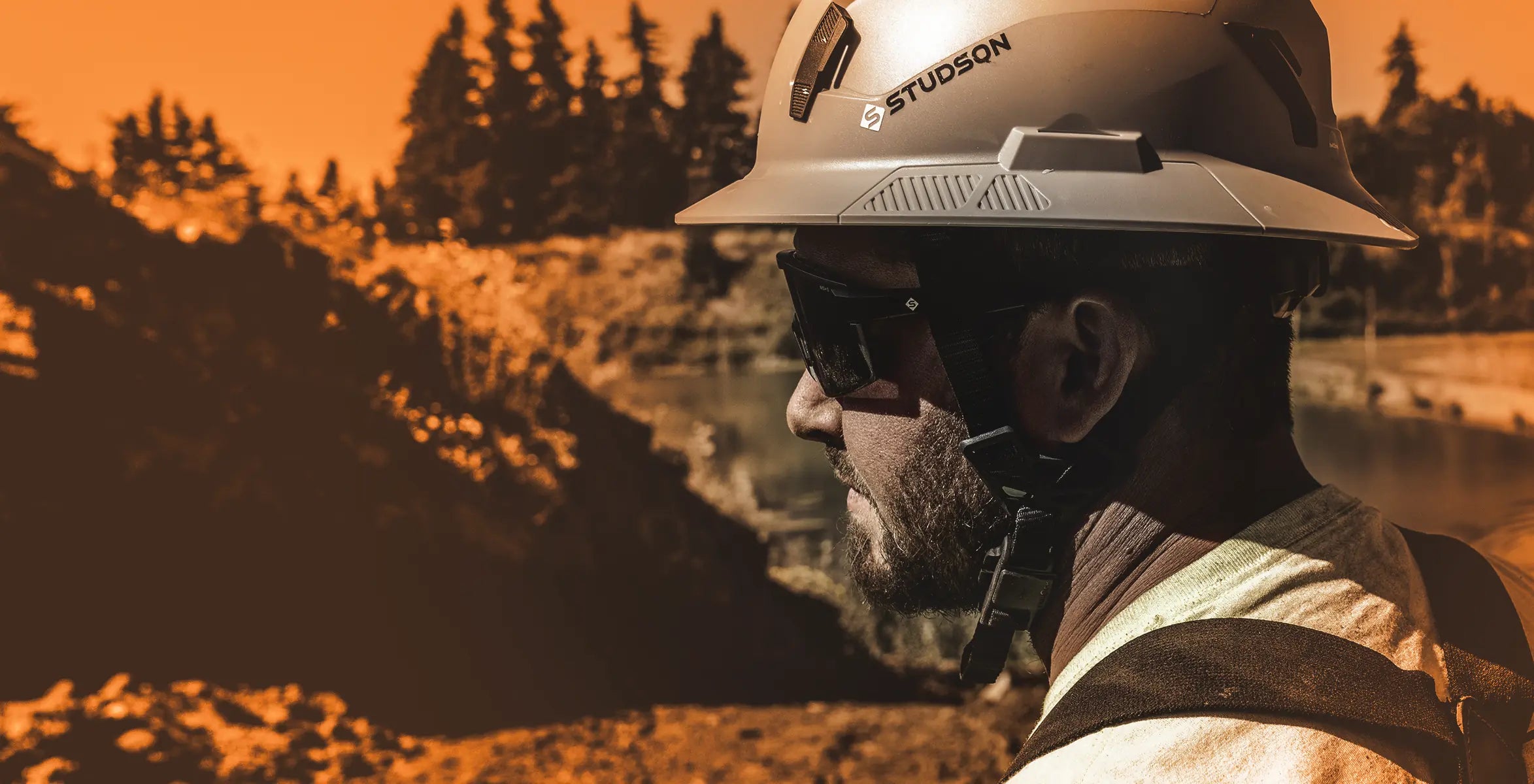 Photo of man wearing safety helmet at construction site.