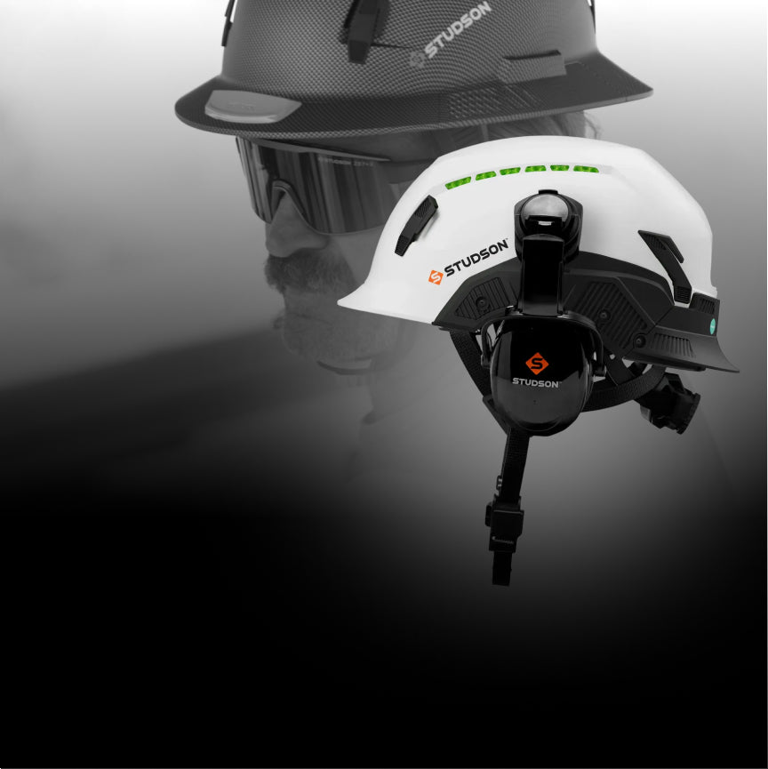 White helmet with black visor and Studson logo on a reflective surface