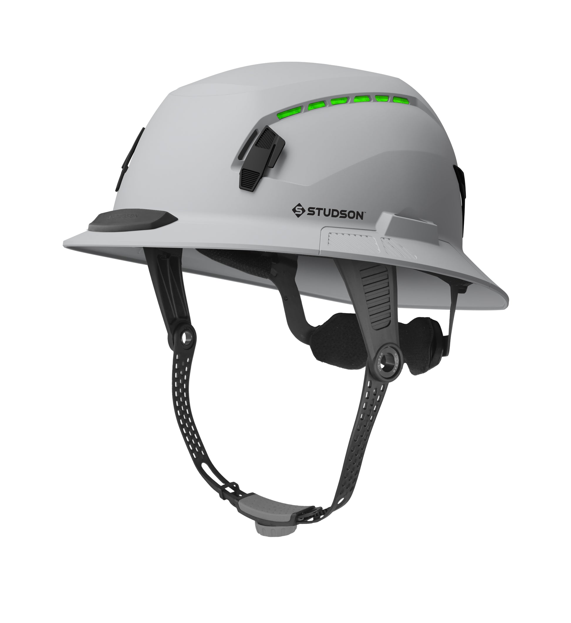 A white STUDSON SHK-1 safety helmet featuring an integrated four-point chin strap, Koroyd material that is visible through the vents, and a sleek, ventilated design for construction and roofing professionals.
